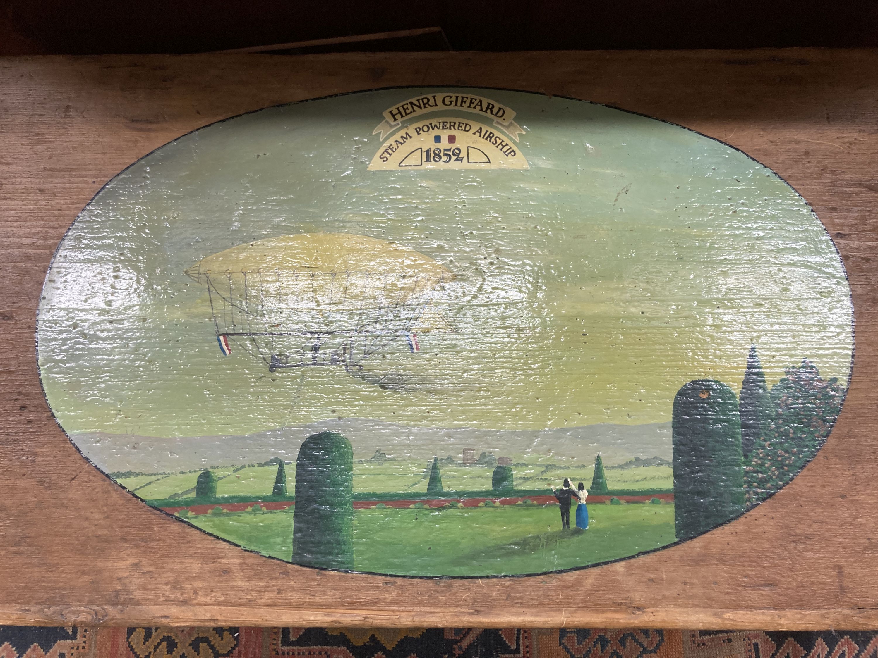 A Victorian stripped pine trunk, the top later painted with an airship scene, length 89cm, depth 37cm, height 50cm